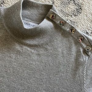 Calvin Klein silver/gray mock neck top with silver buttons on one shoulder